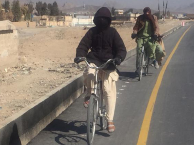 A resident of Kandahar city commuting to school using the new bike lanes built with support from Cities Investment Program